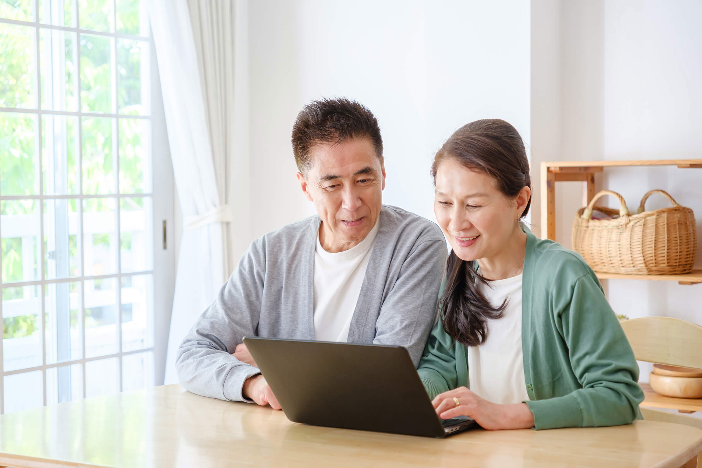 Asian Couple Using Laptop
